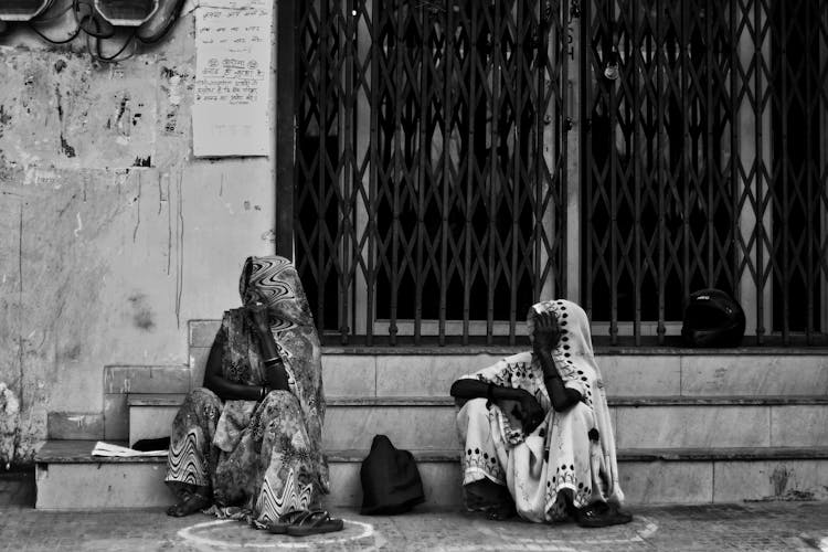 African People In Traditional Clothes Sitting On Street