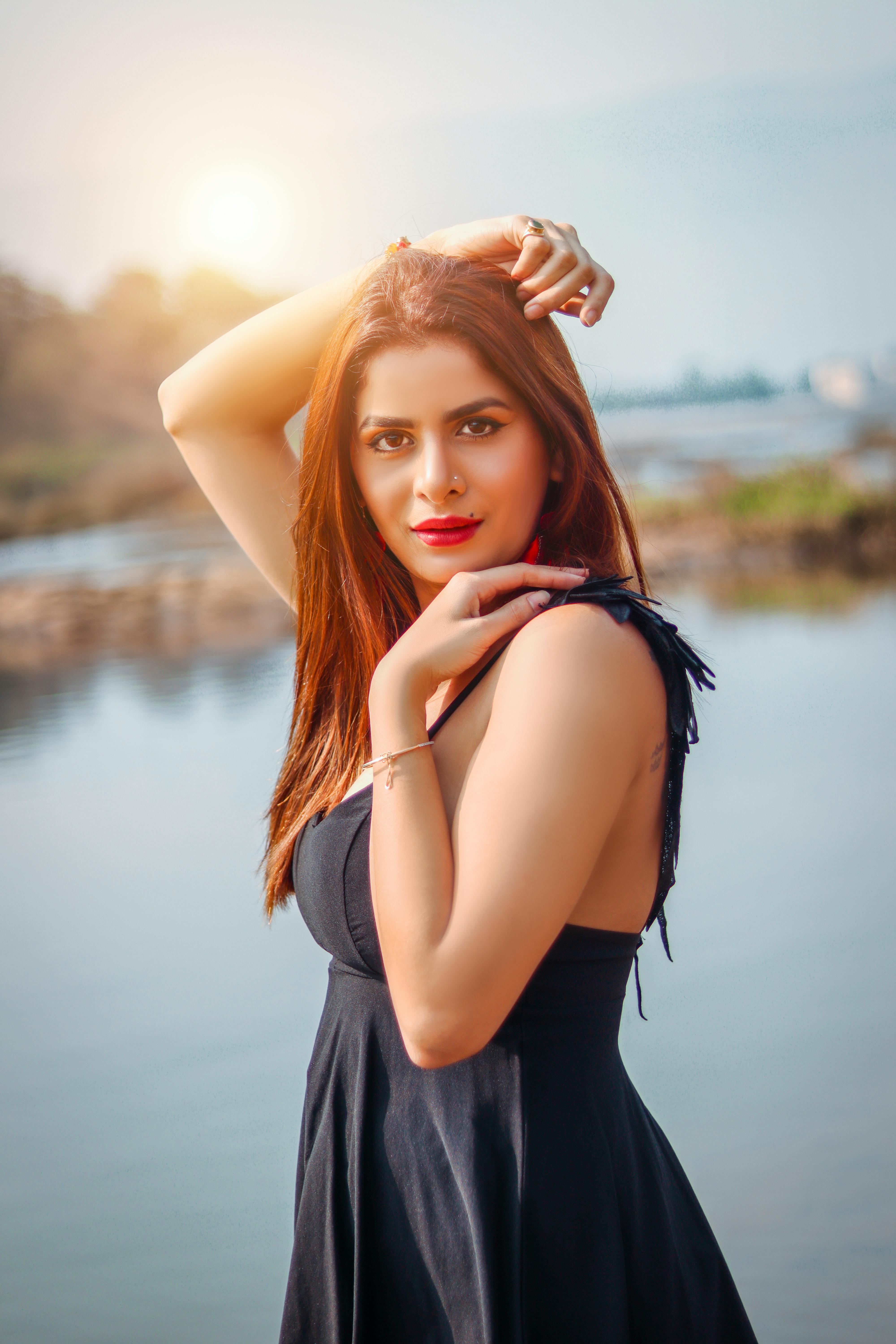 Stunning portrait of a confident woman by the serene waterfront in Mumbai, India.