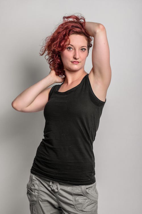 Woman in Black Tank Top Holding Her Hair