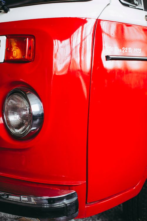 Free Bumper of old fashioned red automobile with round headlight and reflected clean surface Stock Photo