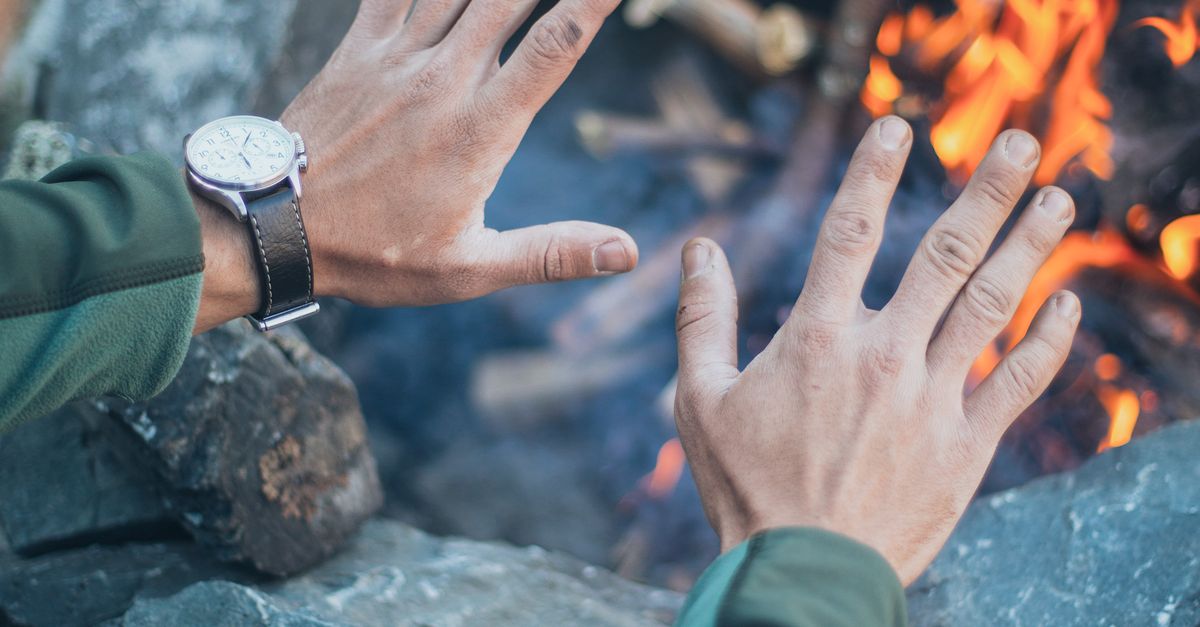 Hand Over Fire Male tourist warming hands over fire · Free Stock Photo