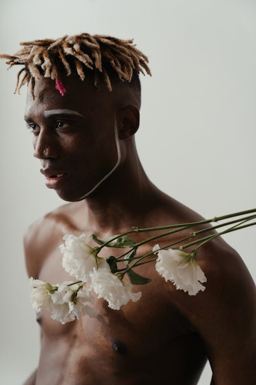 Man With White Flower on His Head