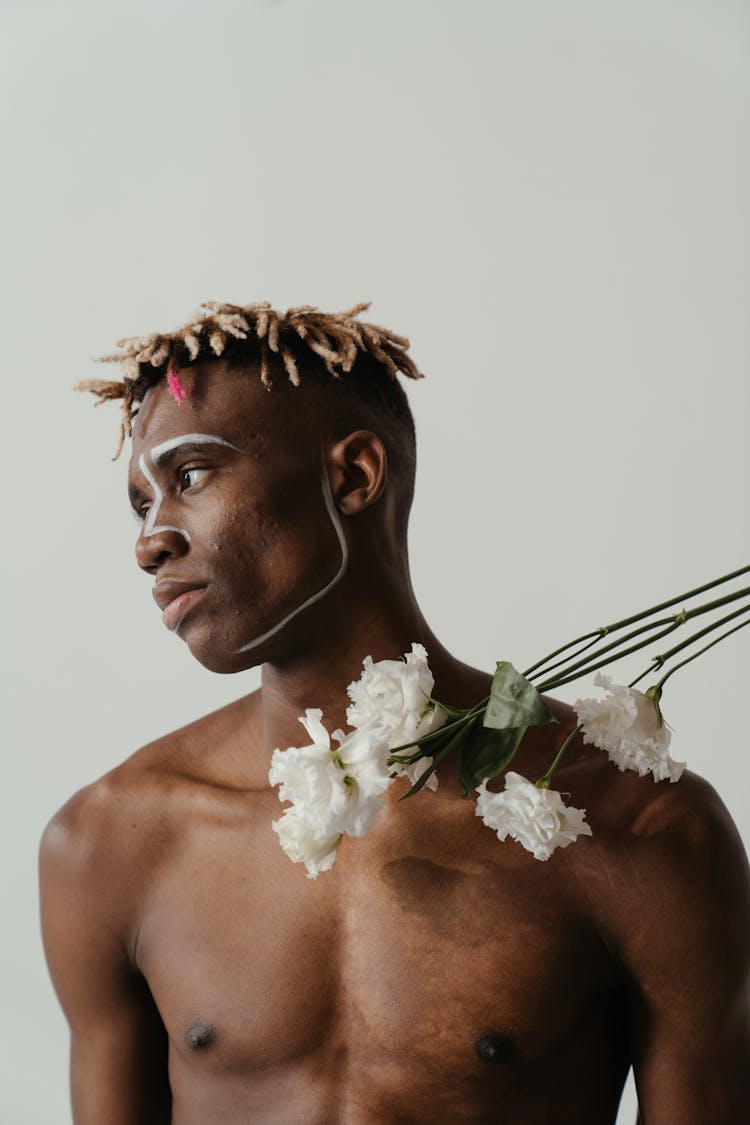 Topless Man With White Flower On His Ear