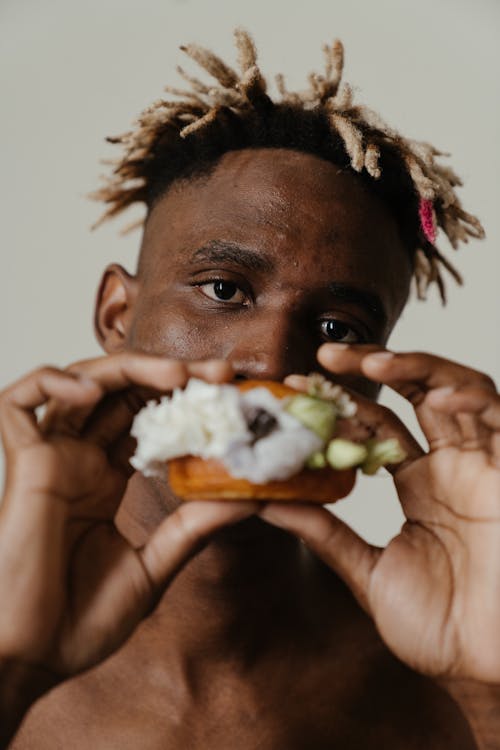 Man Holding Burger With White Cream