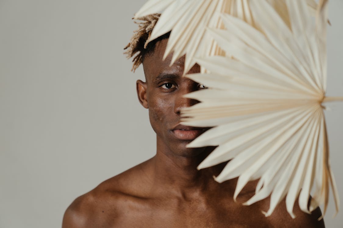 Topless Man With White Feather on His Head