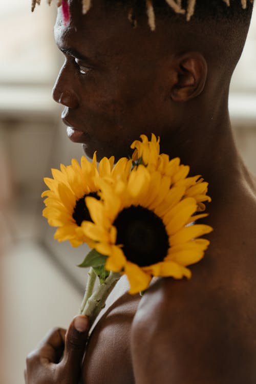 Man Holding Yellow Sunflower