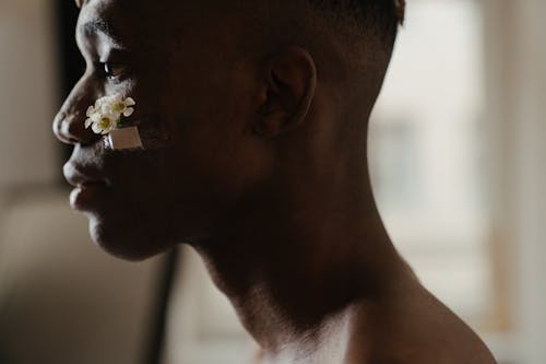 Man With White Flower on Ear