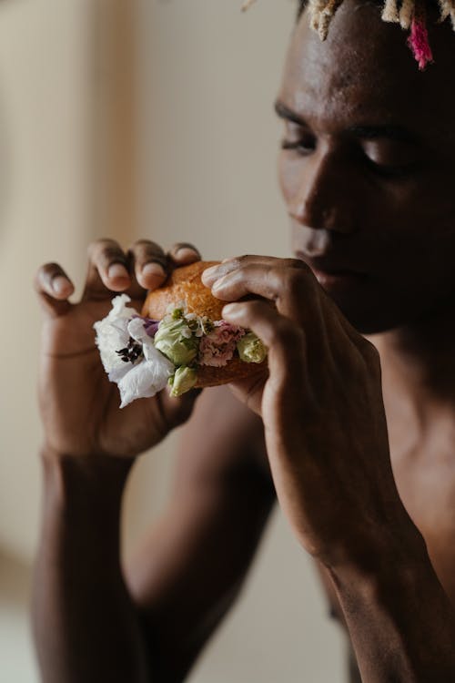 Man Holding White and Brown Flower