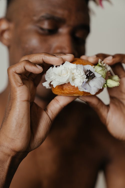 Person Holding White and Brown Pastry