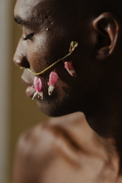 Woman With Pink Flower on Her Ear