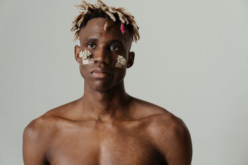 Topless Man With White and Brown Face Paint