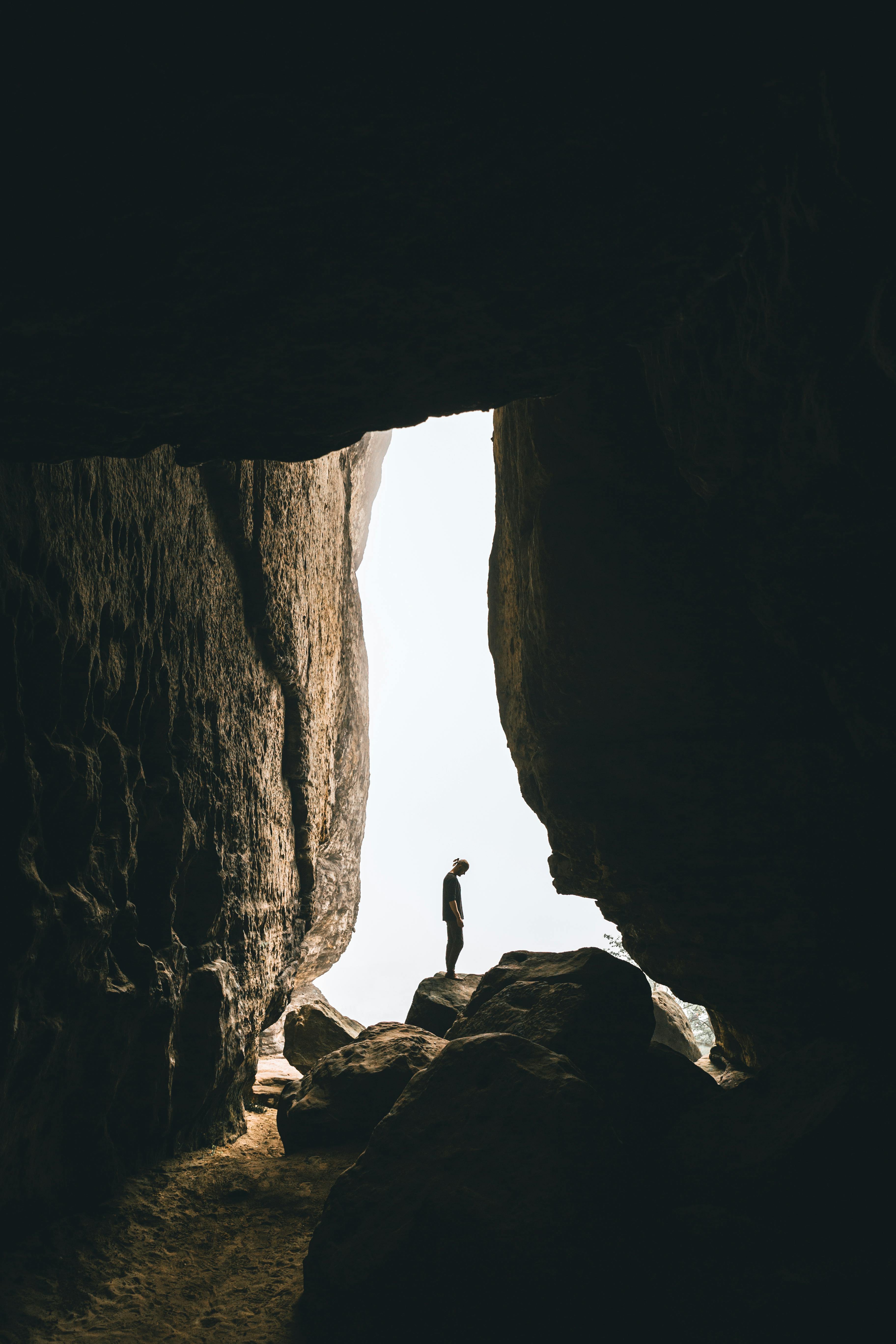 person standing on rock formation