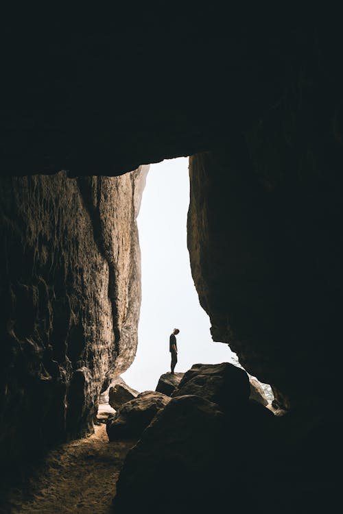 Free Person Standing on Rock Formation Stock Photo