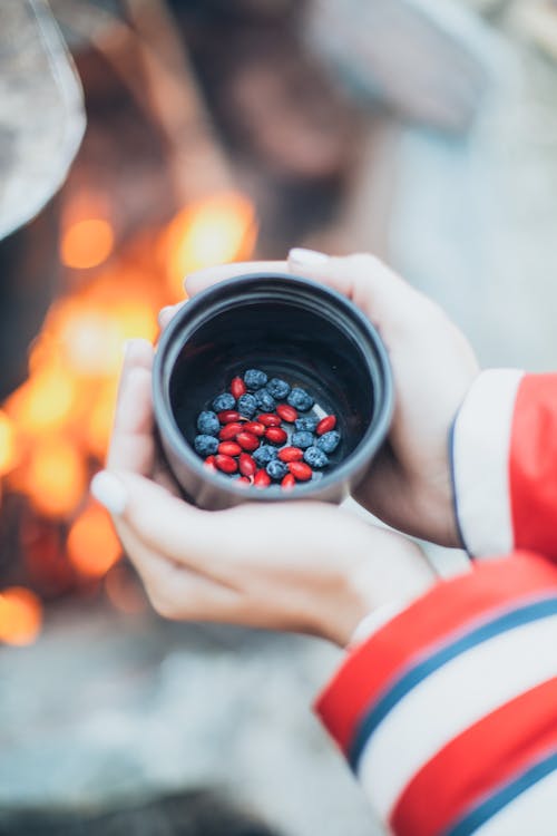 Holding Thermos Cup with Berries