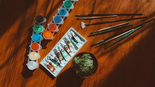 Top View Photo of Art Materials on Wooden Table