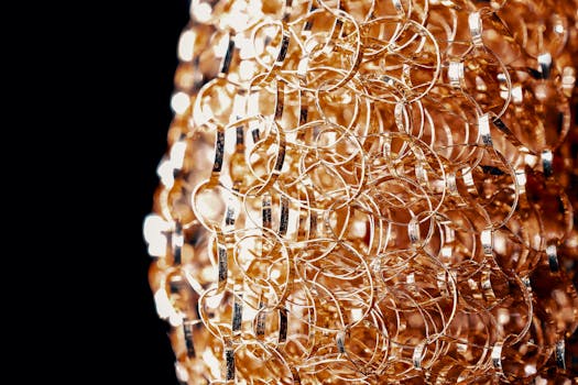 Closeup shiny golden links of fancy decoration chained together on black background