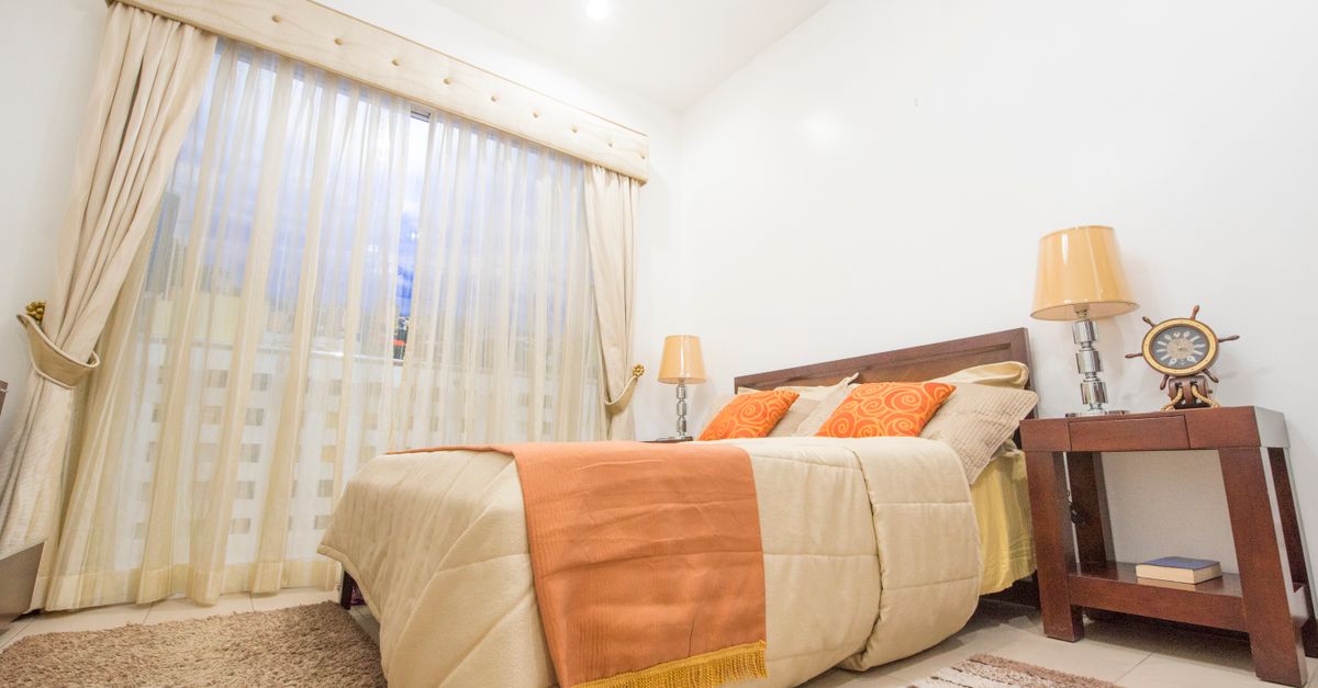 Warm and inviting bedroom featuring chic interior design and modern furnishings.