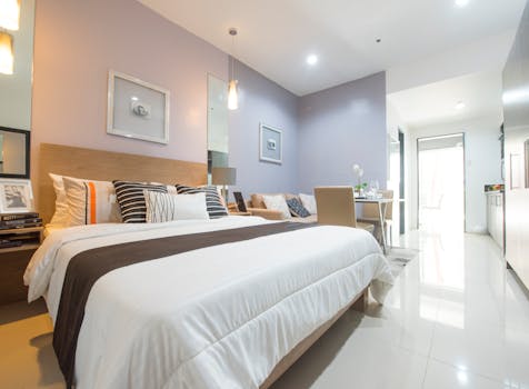 A stylish and cozy bedroom with modern decor, featuring elegant lighting and a comfortable bed.