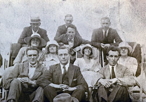 Grayscale Photo of Group of Men and Women