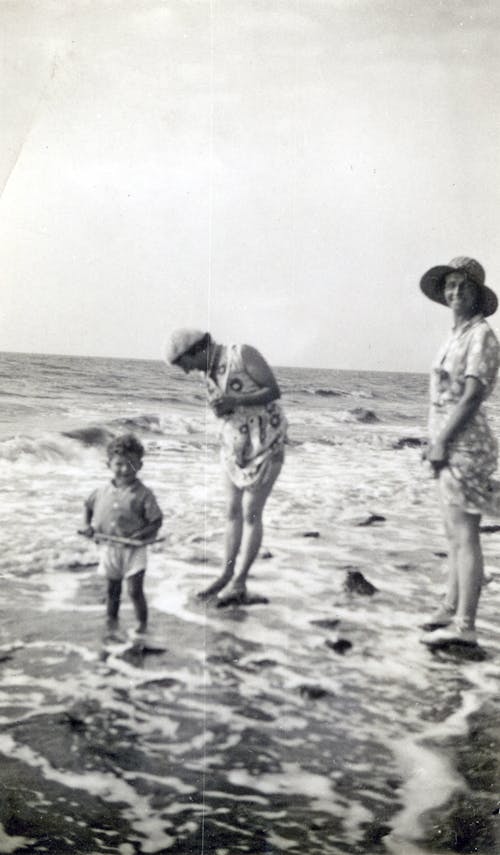 Photo of Family Standing on Seashore