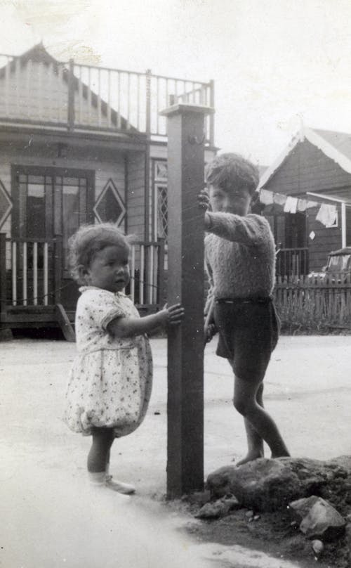 Photo of Kids Standing by the Post