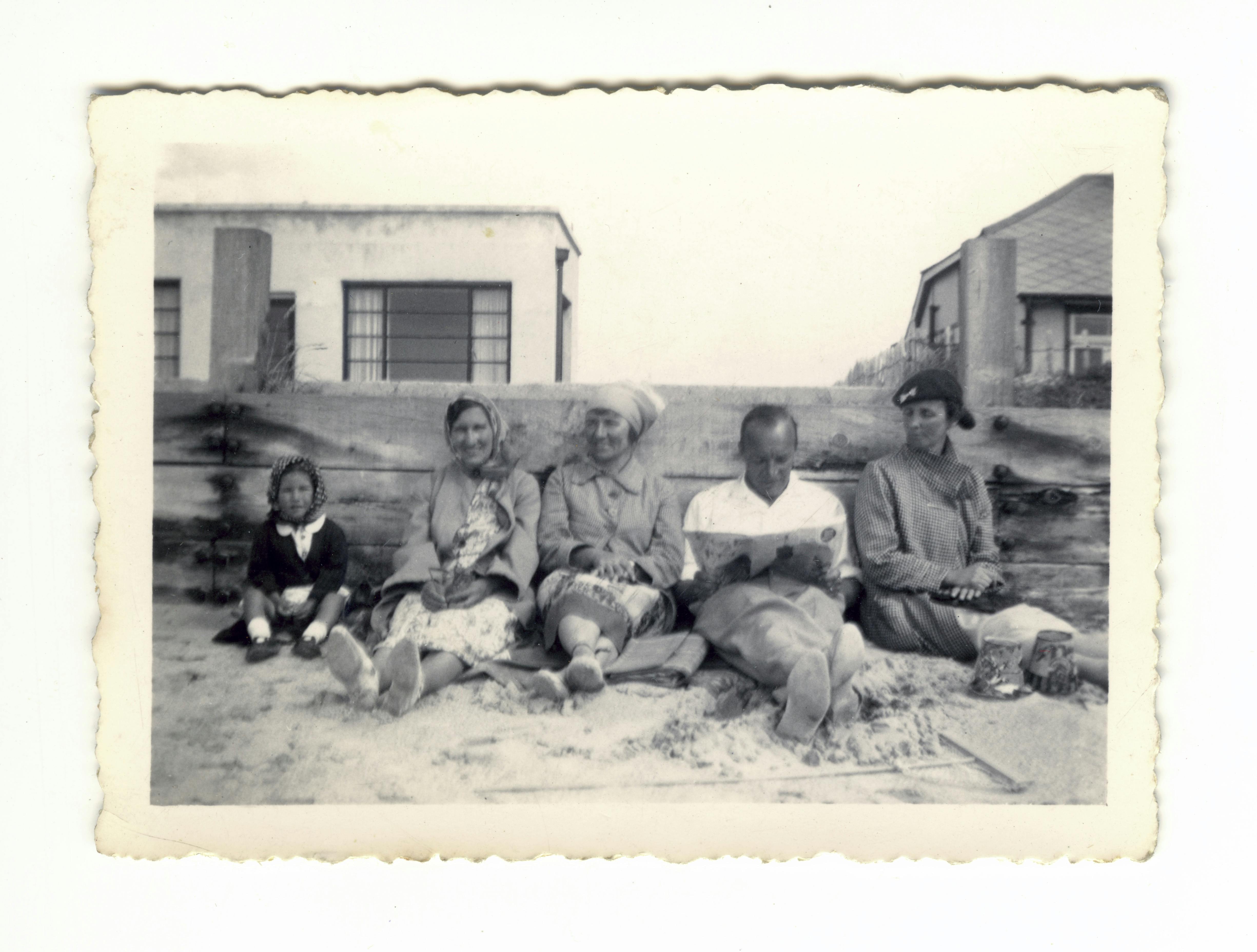 A classic vintage photo of a family enjoying time together at the beach.