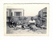 Grayscale Photo of People Sitting on Ground