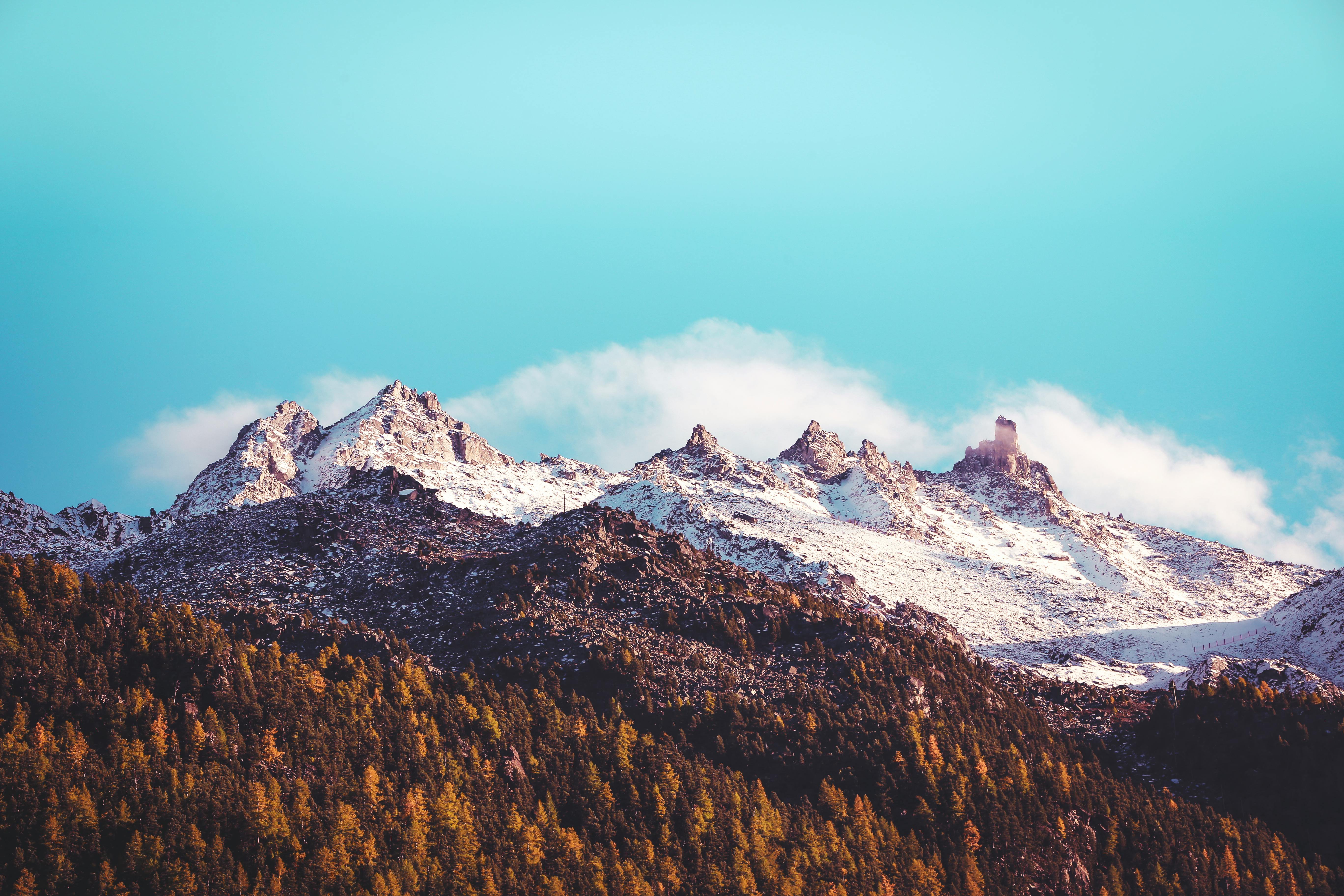 Brown and White Mountains Under Blue Sky