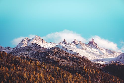 Brown and White Mountains Under Blue Sky