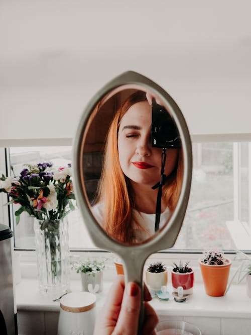 Woman in Red Lipstick in Front of Mirror