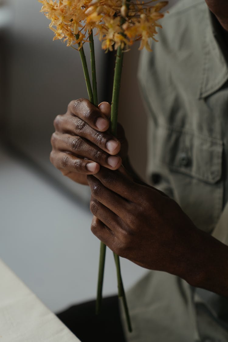 Person In Gray Button Up Shirt Holding Flower