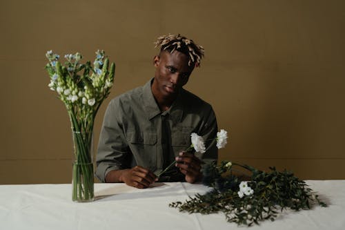 Man in Gray Dress Shirt Sitting at the Table