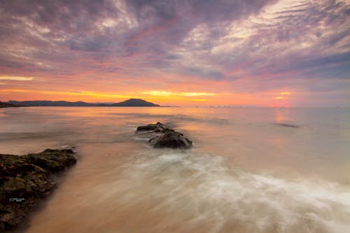 Time-lapse Photograph of Seashore during Golden Hour