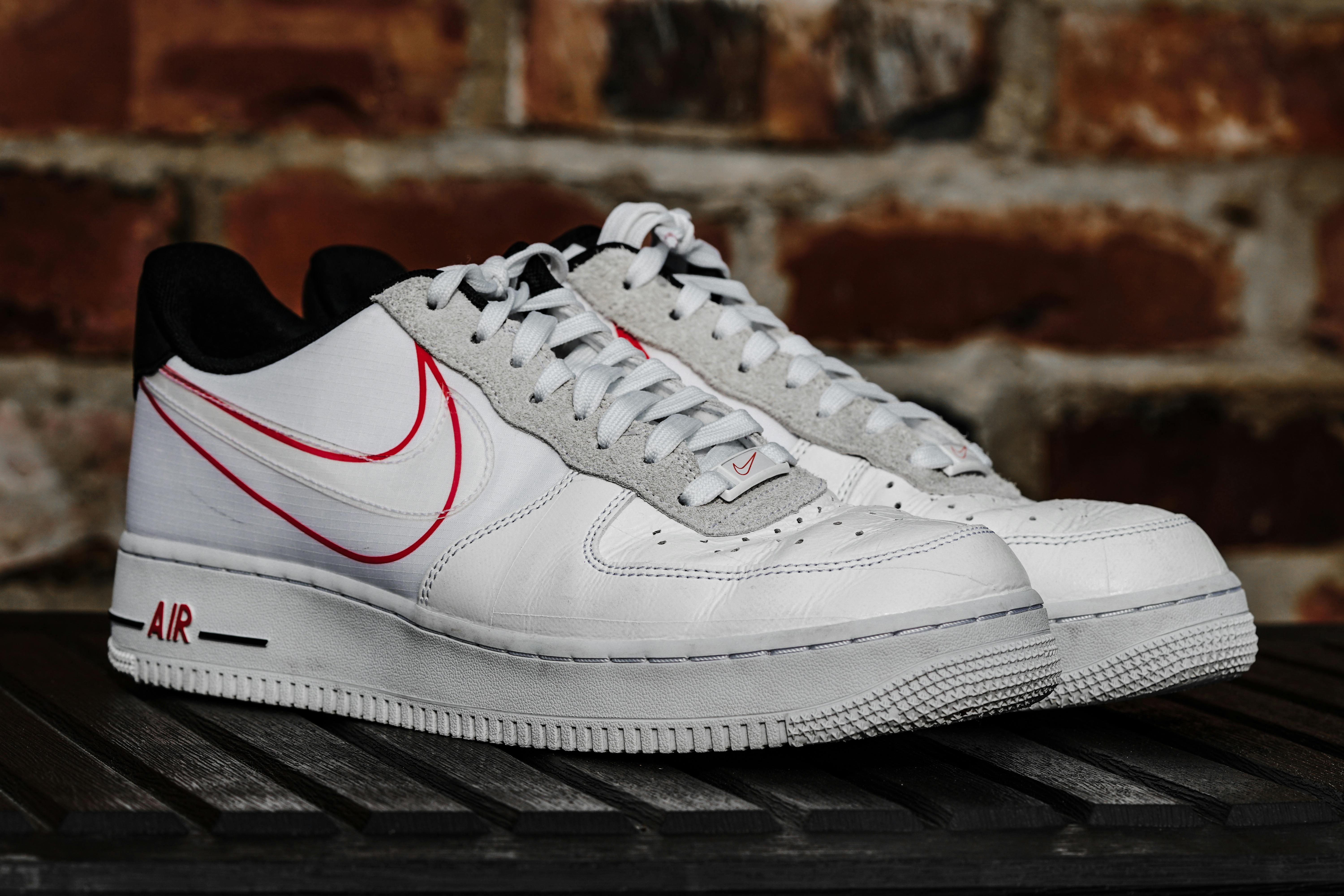 white and red nike shoes