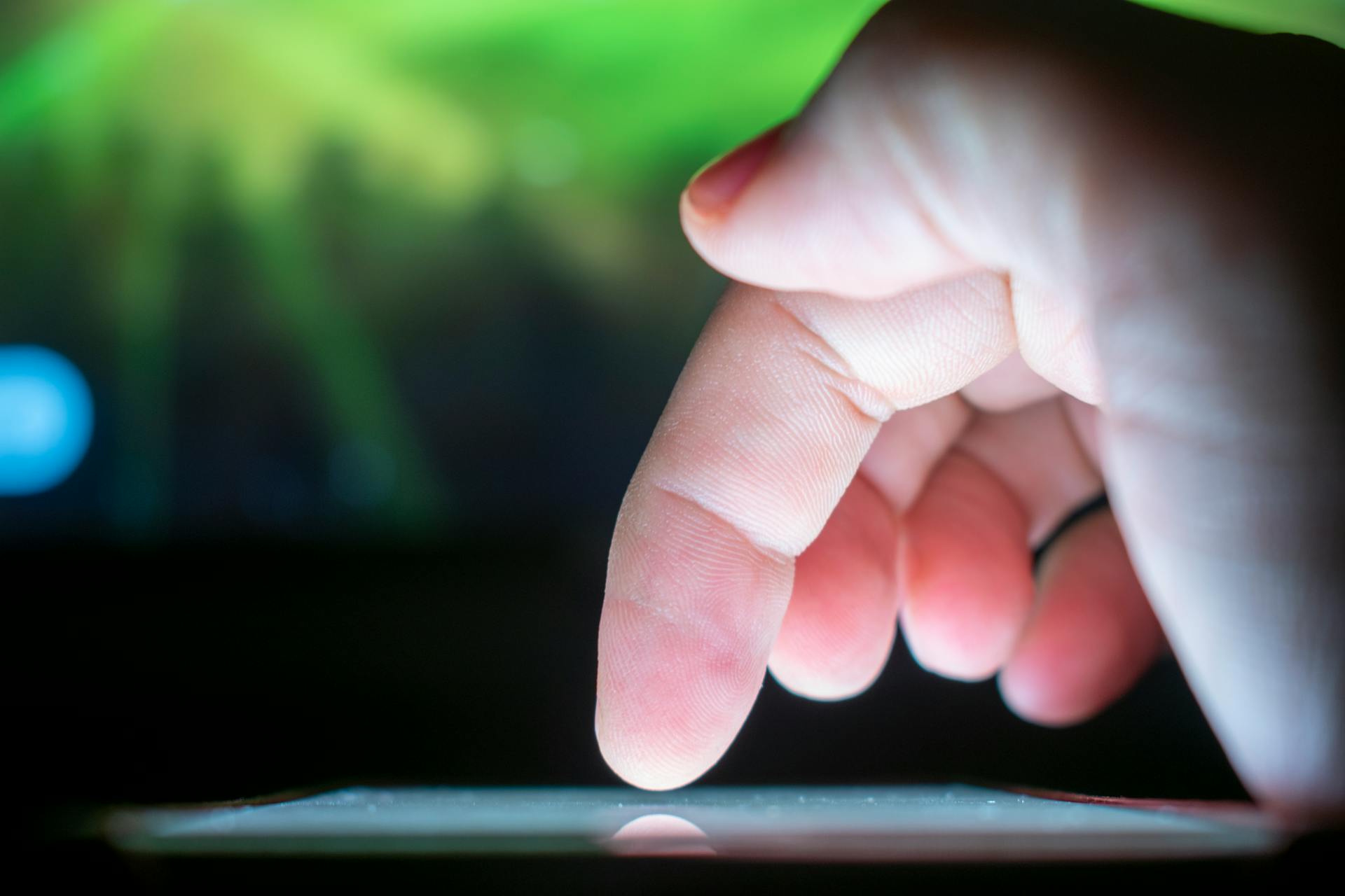 Close-up of a finger interacting with a touchscreen, capturing a moment of technology use.