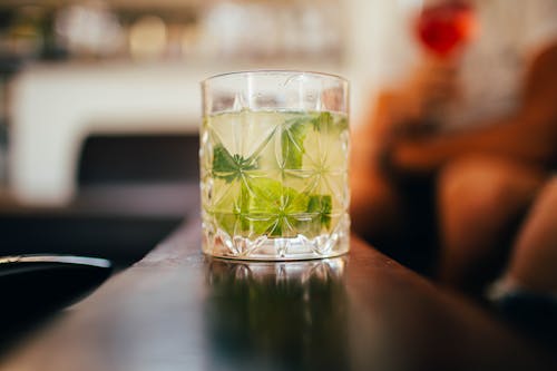 Clear Drinking Glass With Green Leaves