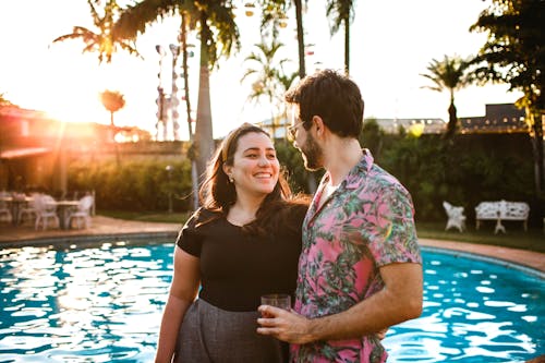 Man and Woman Standing Beside Swimming Pool