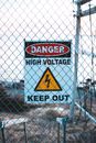 Signboard with of high voltage on fence