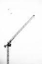 Metal crane under sky with long jib