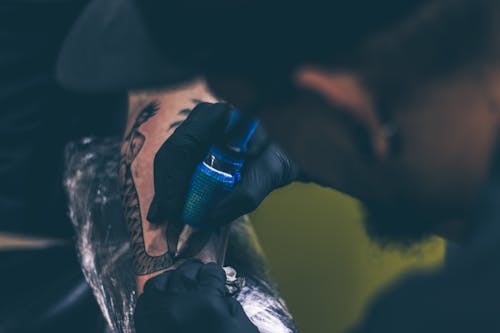 Free Man Tattooing Person on Arm Stock Photo