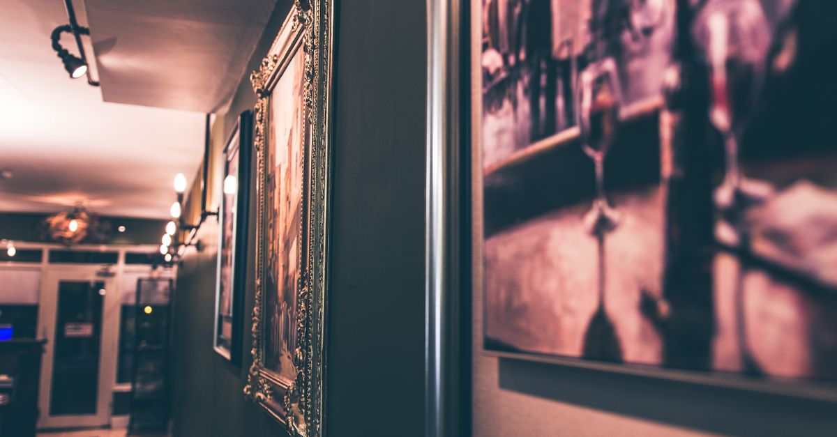 Blurred view of an elegant corridor adorned with framed paintings, perfect for business or travel themes.