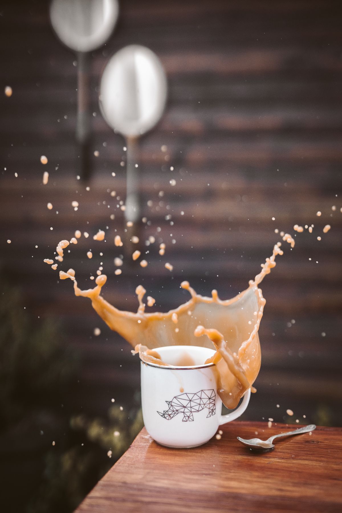 Coffee splashing out of a tipped mug &mdash; the moment a stain begins
