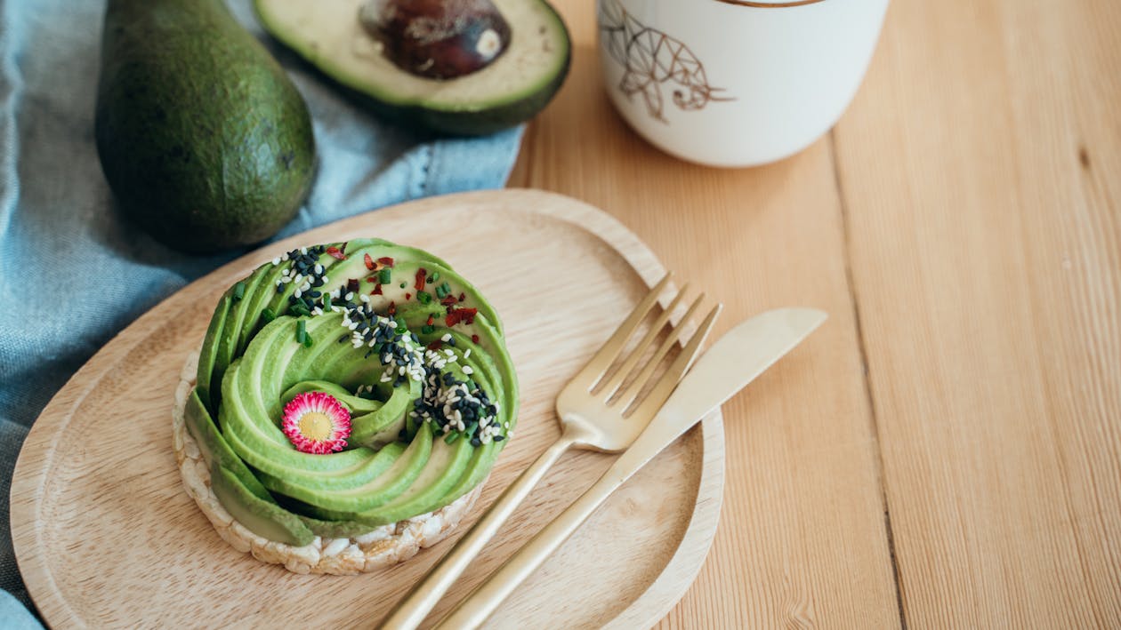 Free Green and Black Cake on Brown Wooden Table Stock Photo