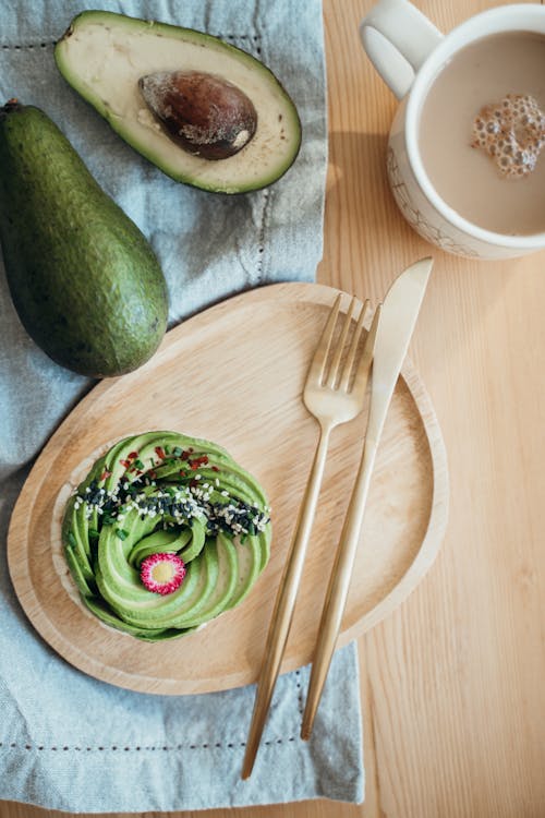 Free Photo Of Sliced Avocado Fruit On Wooden Plate Stock Photo