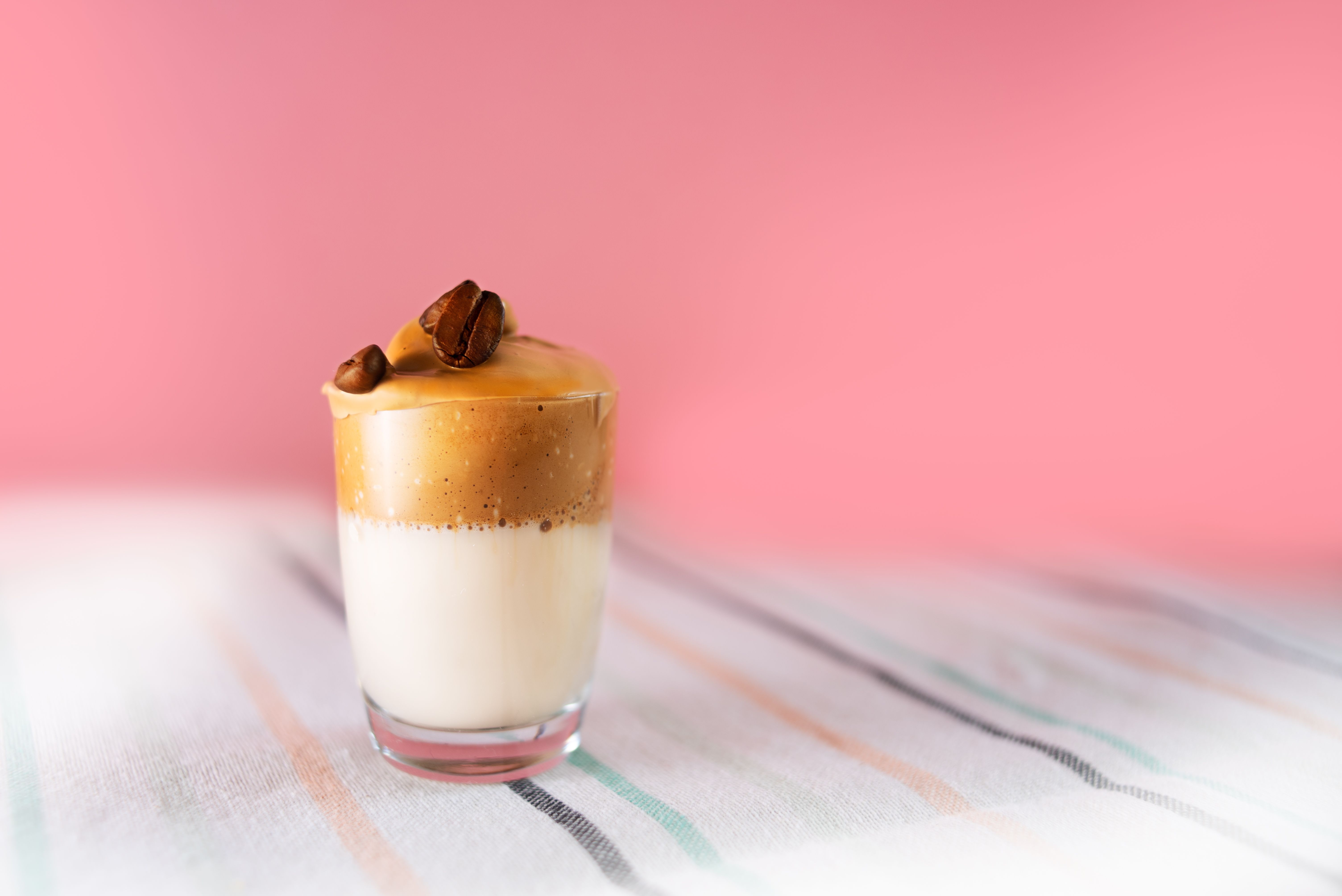 homemade mocha latte recipe - Aesthetic shot of dalgona coffee with creamy foam and topped with coffee beans.