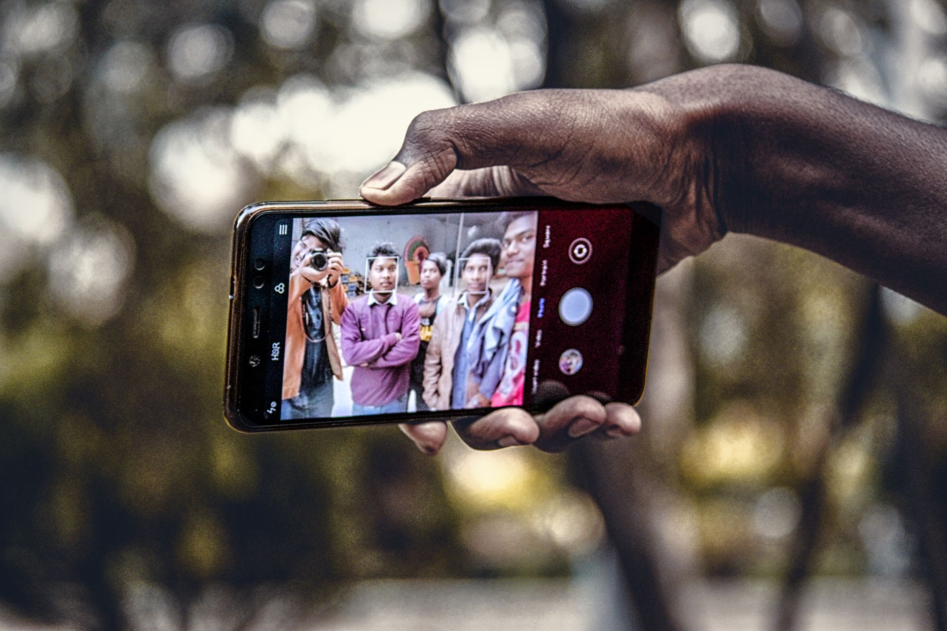 Close-Up Shot of a Person Holding a Mobile Phone while Taking Picture