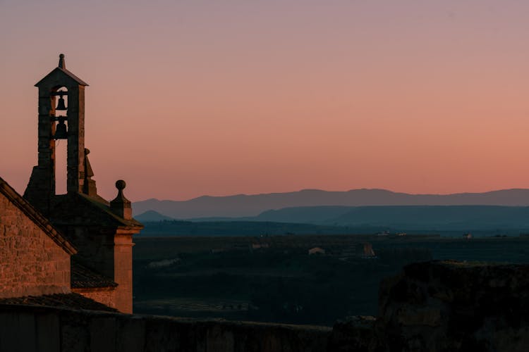 Medieval Church Bell Tower During Sundown In Valley