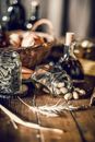 Small peanuts in shell spilling from transparent jar on wooden table in daylight on blurred background