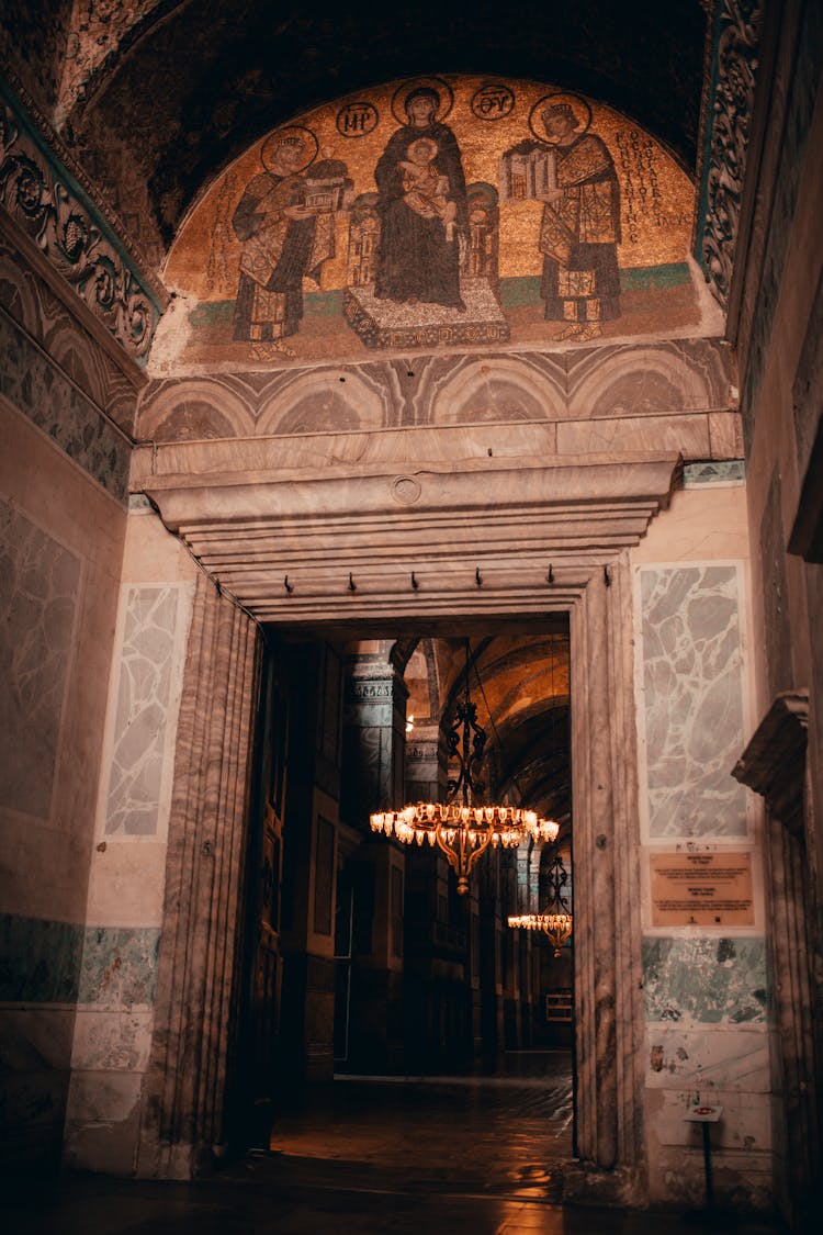 Old Church Interior With Mural And Shining Chandeliers