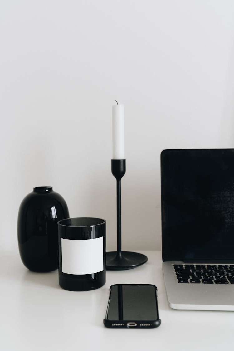 Laptop And Smartphone With Set Of White And Black Items